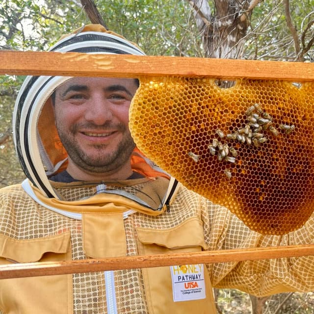 Prof. Dr. Ferhat Öztürk holding a honeycomb frame